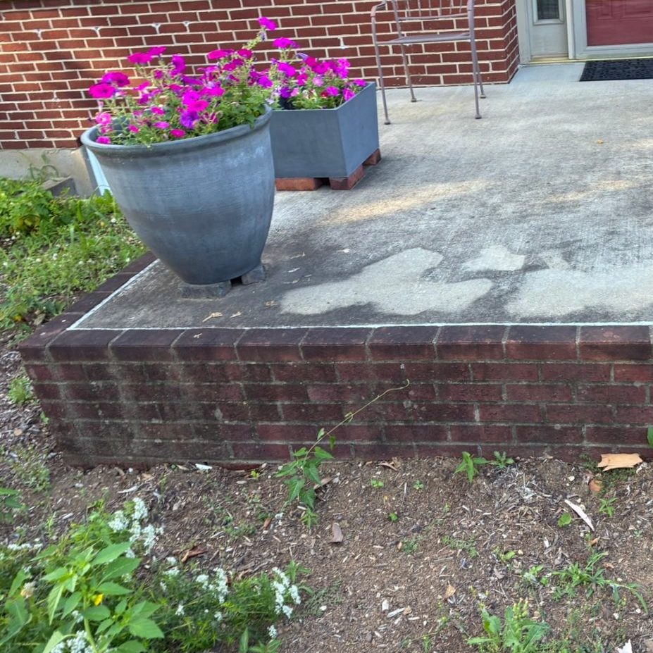 Concrete front porch before pressure washing — stained and grimy