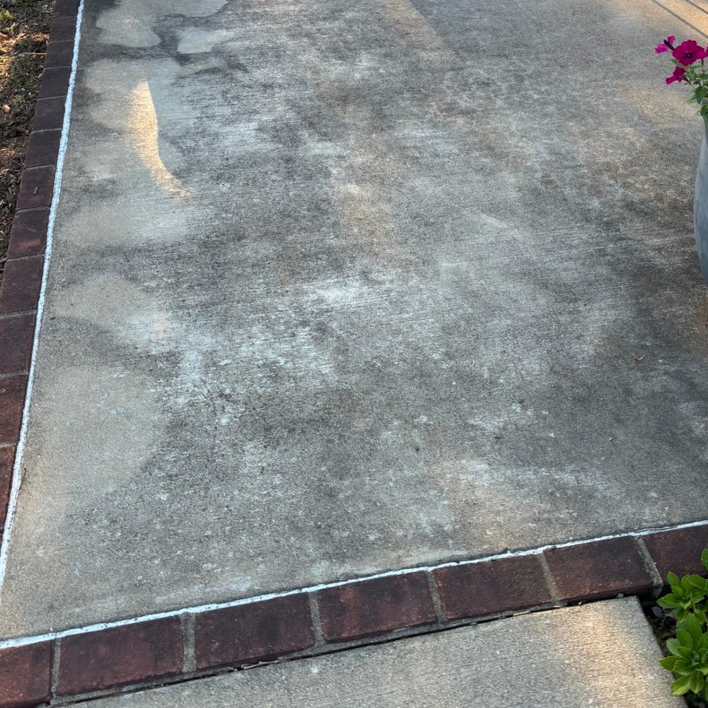 Side patio before pressure washing — dark buildup on concrete